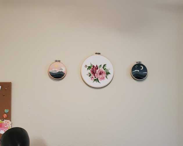 Hung up pieces of embroidery, sun, peonies, and moon